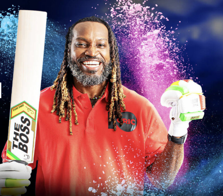 Cricketer with dreadlocks holding up a cricket bat